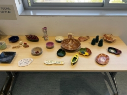 Various works of pottery and sculpture displayed on a table