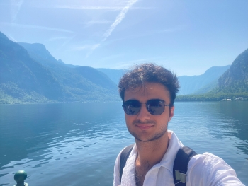 Selfie of Aras with a mountainous lake background of Hallstatt, Austria