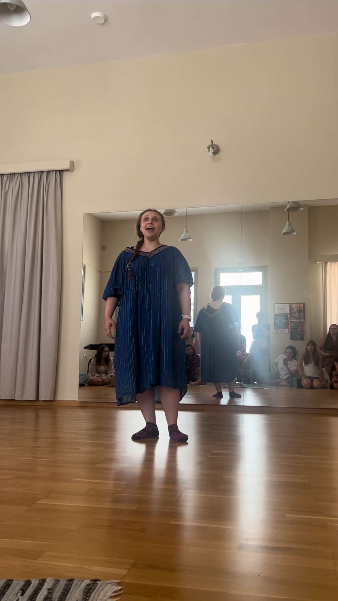 Bethie singing in front of a studio of other students