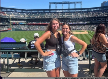 Ella and Madi pose at a Colorado Rockies baseball game