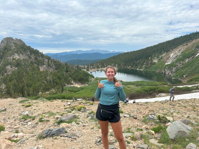 Ella flashes two thumbs up while on a hike in the Colorado Rockies.