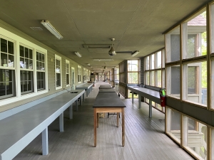 The image shows a long hallway with several wooden benches. This is part of the Baruch Marine Field Laboratory.