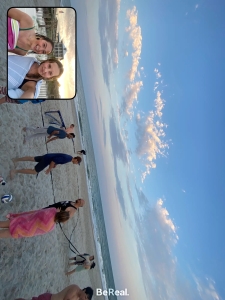 Image shows Emma and the other interns/employees playing sand volleyball and swimming