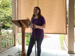 Julia reading behind a podium