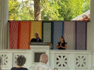 Two writers answering questions on a stage