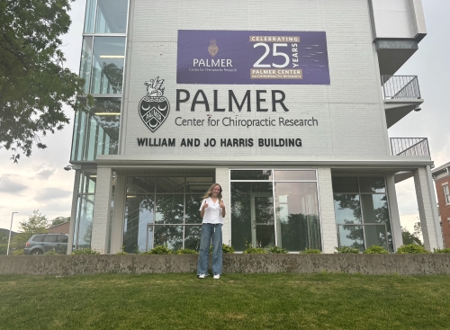 Kylie in front of the Palmer Center for Chiropractic Research