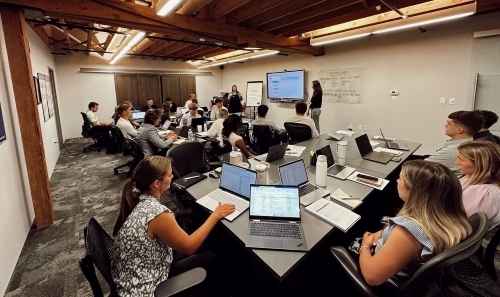 A view of several interns and other professionals working in an open office environment