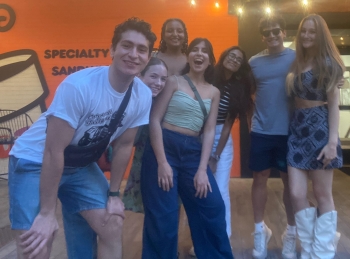 Laura, Moodi, and the other interns pose in the lobby of their favorite Italian restaurant