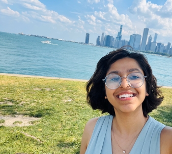 Selfie of Smriti with the Chicago skyline and lake in the background.