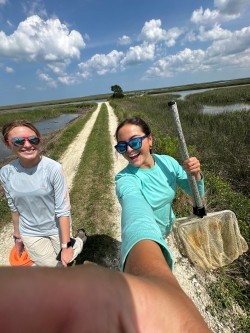 Anna poses with another intern while out doing field work. The other intern's arm can be seen in the shot, taking this selfie
