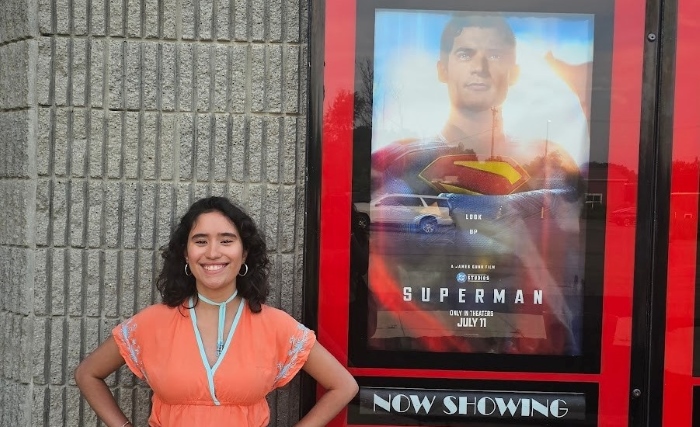 Claudia posing next to the new Superman movie poster