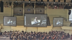 View of a symphony orchestra just below a screen showing Captain Jack Sparrow from the film Pirates of the Caribbean