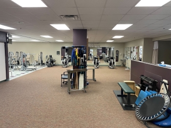 Physical therapy room full of exercise equipment