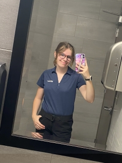 Bathroom selfie of Celina in her Mister Car Wash polo uniform