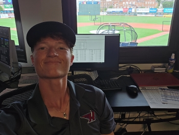 Selfie of Evan in the press box, a slightly assertive look on his face