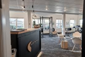 View of the PT clinic lobby area seating and front desk