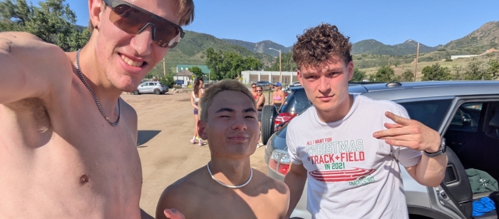 Selfie taken by Isaac of himself and two friends outdoors, Isaac and the friend to his left shirtless