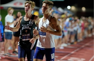 Close up of Isaac and another runner, neck and neck in a race to the finish line