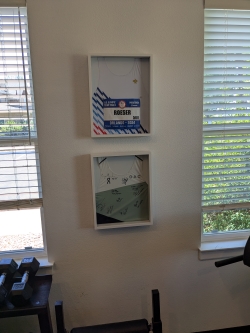 Mounted frame in two rectangular parts holds a singlet and race bib from the Olympic trials in Orlando in 2024.