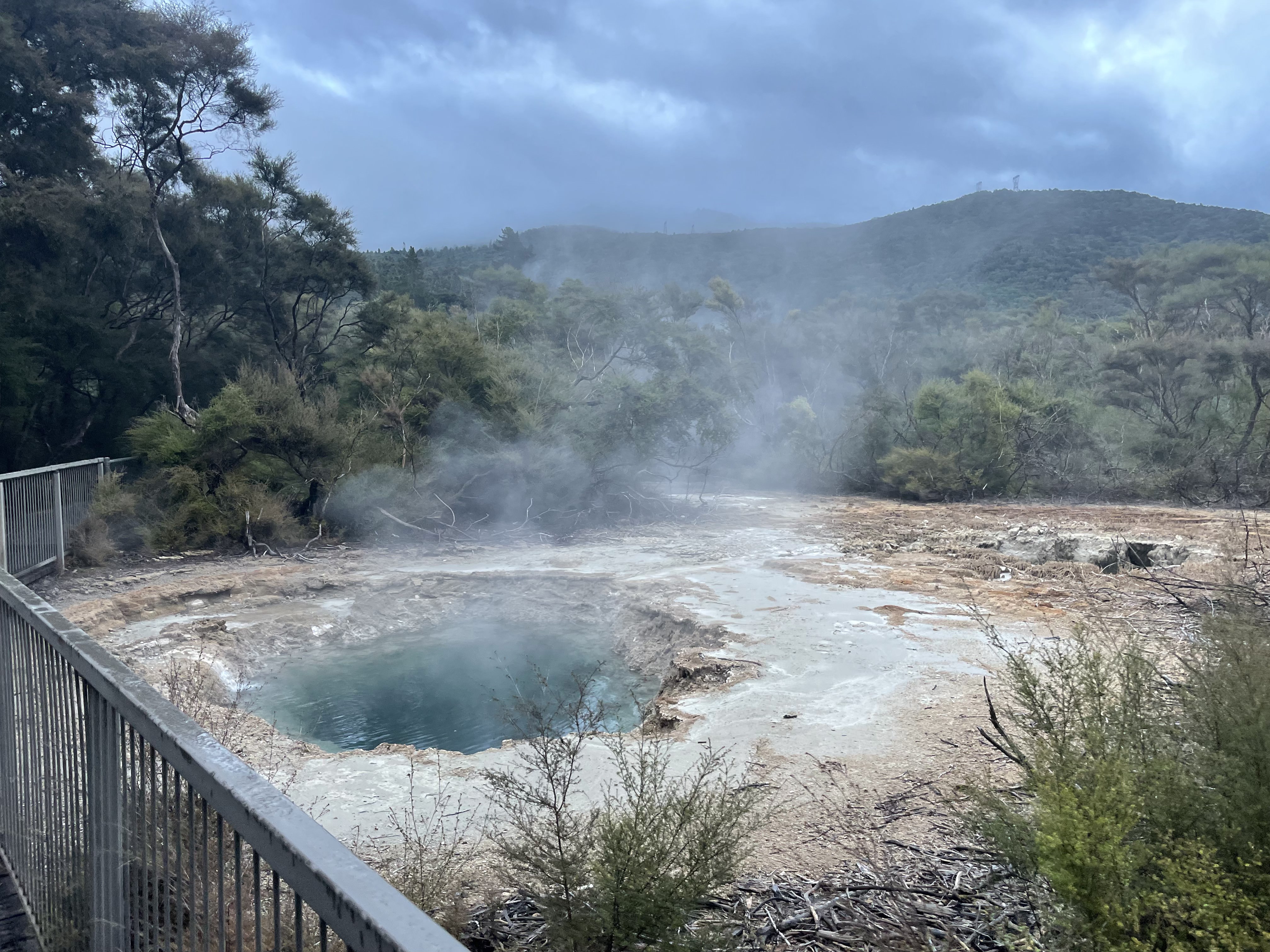 An outdoor photo of a steaming hot spring