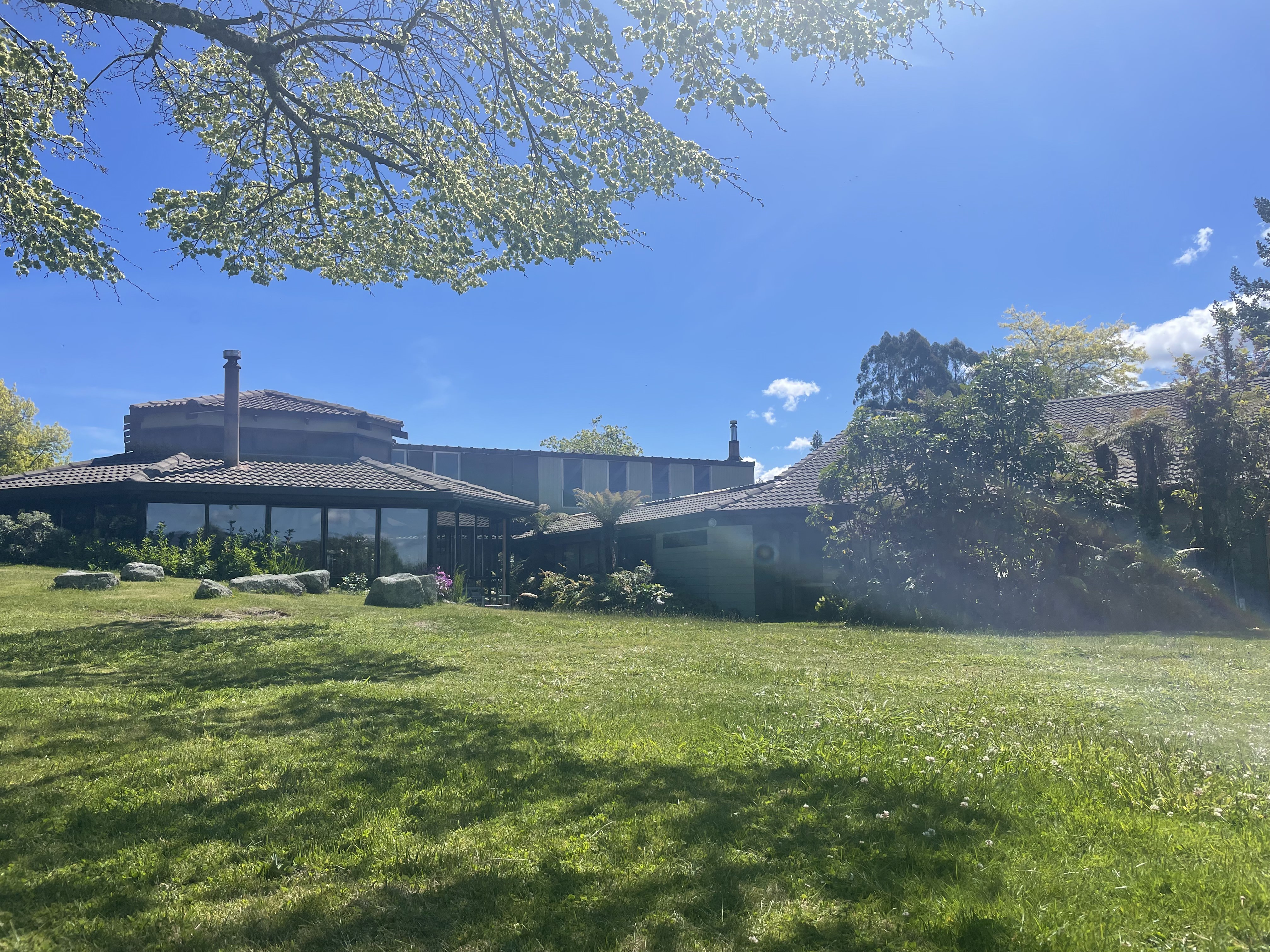 An outside picture of the Tauhara Centre surrounded by foliage