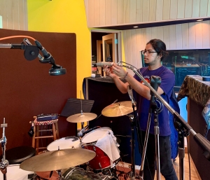 Oskar working on placement of Neumann U67 microphone for a drum recording session