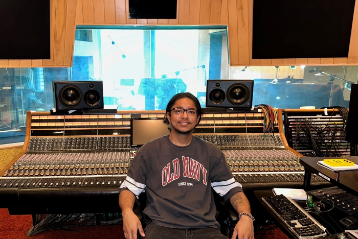 Oskar is seated in a music recording studio with a 48-Channel Discrete console behind him.