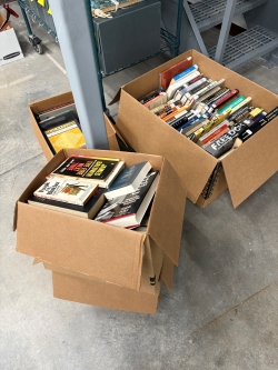 Two big boxes and one small box full of books about Black people, their history, and their experiences