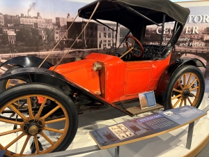 A pre-Ford electric car, colored red