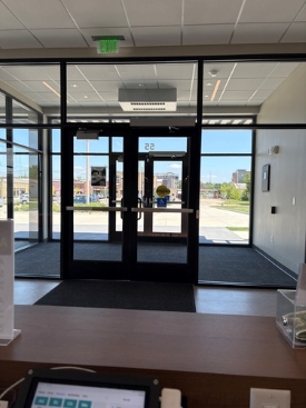 Orion's view from the front desk of AAMI shows two sets of double doors with clear glass showing a parking lot outside.