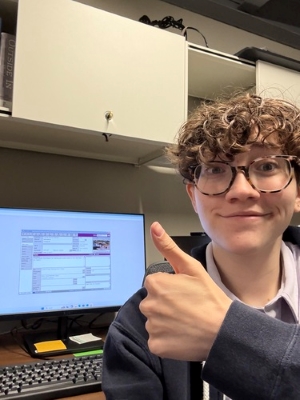 Selfie of Orion at his desktop computer scanning photographs for the museum