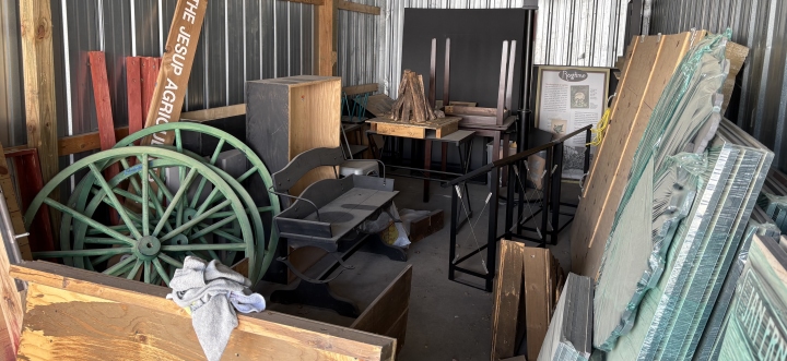 Storage unit full of wagon pieces and other museum objects