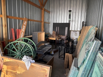 Storage unit containing pieces of a wagon and other museum objects