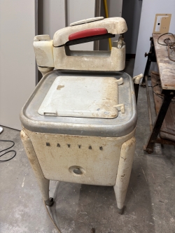 View of a cleaner but still buffed and slightly rusty 1930s Maytag washing machine