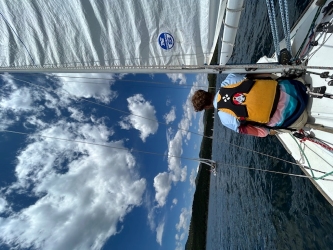 Under sail on Carter Lake with brother, Luke, who is working the foredeck