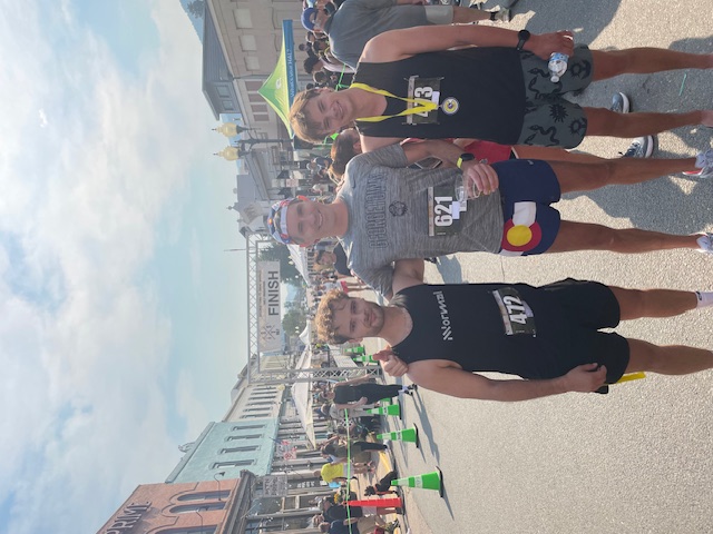 Sean and Luke and a friend at the finish line after running a half-marathon