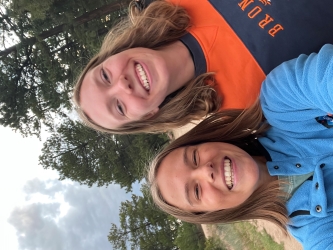 Selfie of Sophie and Zoe smiling in an outdoor camp setting
