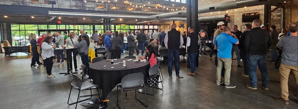 Large crowd mingling in an indoor space for the Build the QC event
