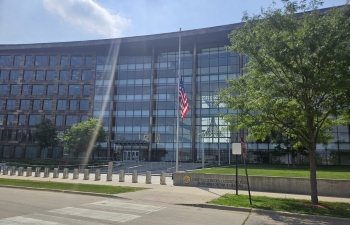 View of the front entrance to the U.S. Federal Courthouse in Cedar Rapids. The building is modern with floor-to-ceiling glass windows across the front of the building.