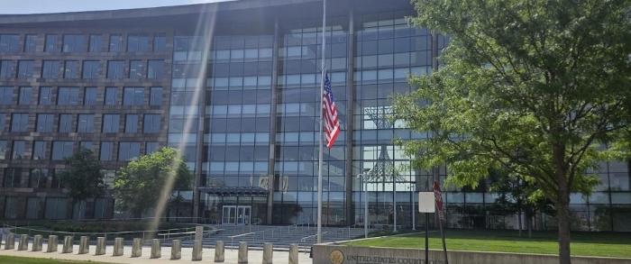 View of the front entrance to the U.S. Federal Courthouse in Cedar Rapids. The building is modern with floor-to-ceiling glass windows across the front of the building.