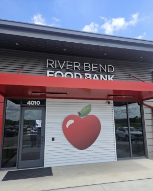 Facade of the River Bend Food Bank with red trim on the awning