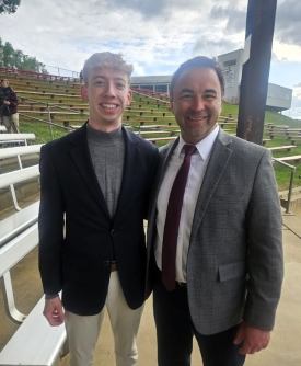 Tyler poses with Dubuque mayor Brad Cavanagh, both wearing dark suit jackets