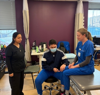 This image shows a Physical Therapist and Speech Pathologist. The PT was showing me different ways to test for reflexes.