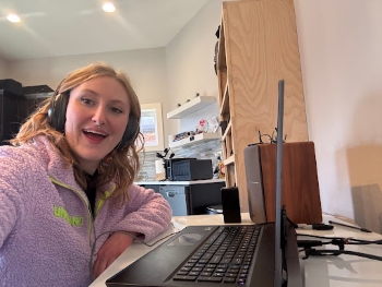 Chrysalis in the office sitting in front of a laptop