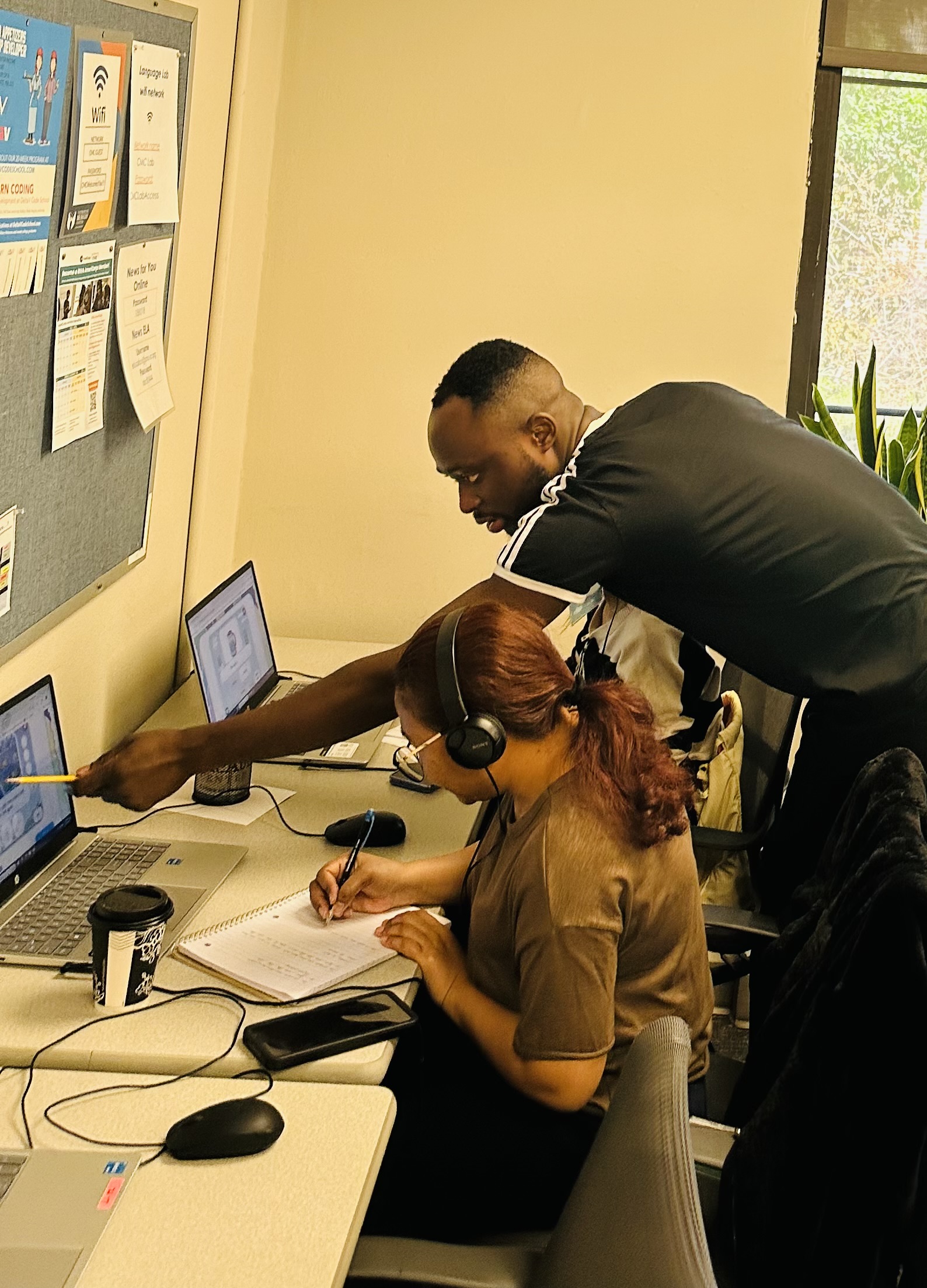 a teacher works with an adult learner