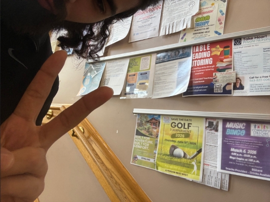 Image is a selfie Ricky took with a poster he hung up for a listing.