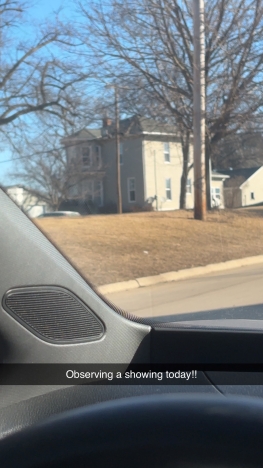 Image shows an image of a house through a car window and is captioned "Observing a showing today!!"