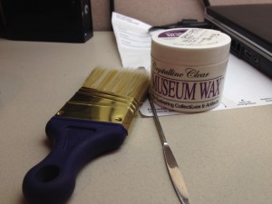The brush is for cleaning the plastic and display base, the fancy wax for securing the plastic, and the spatula, while a pretty multifaceted tool when working in archives, helps secure the plastic as well.