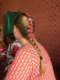 Taylor with braid in hair and flowers tucked into the braid